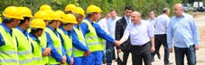 PM Vano Merabishvili shakes hands with construction workers the Ruisi-Agara sector.