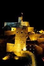 An illuminated night view of Rabat Castle.